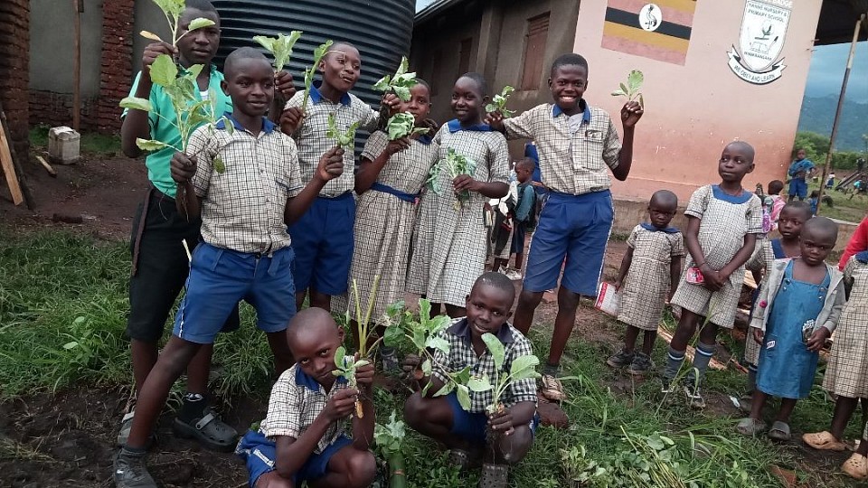 Pupils of hanne primary school holding vegetables for their kitchen garden